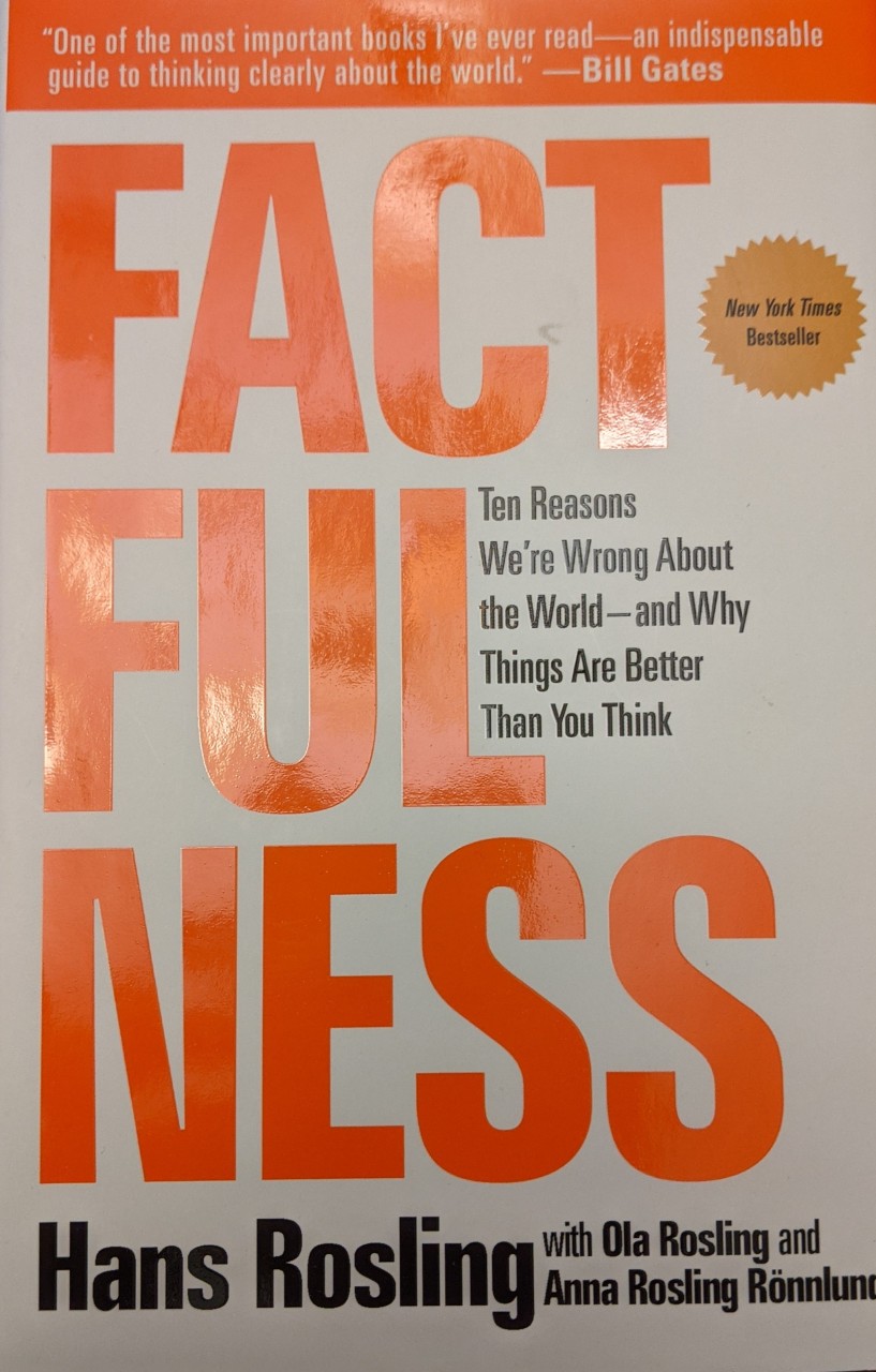 The book cover for Factfulness features the word factfulness in large orange print