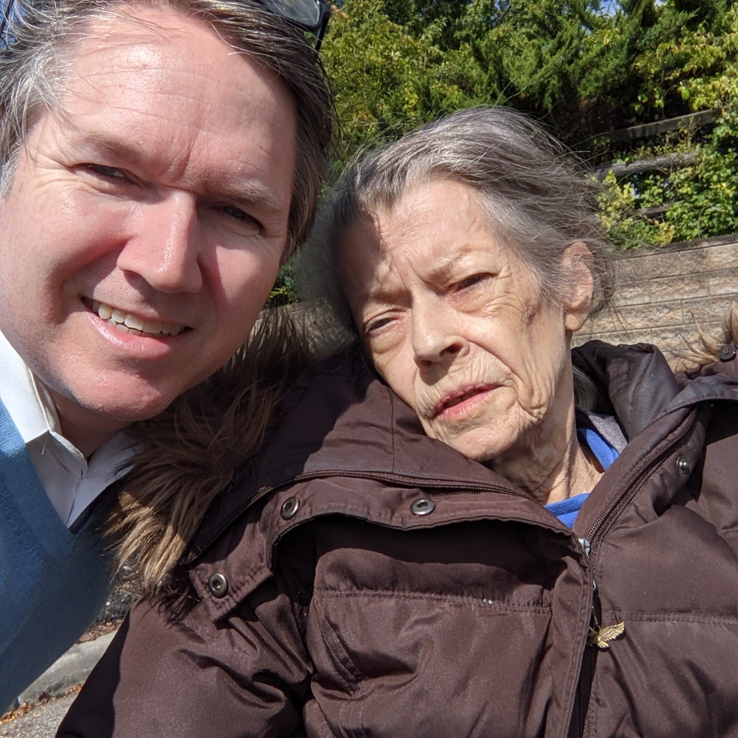 A selfie of the author with his mother on a sunny day